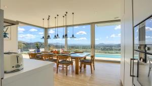 a kitchen and dining room with a table and chairs at Rock Villa in Pollença