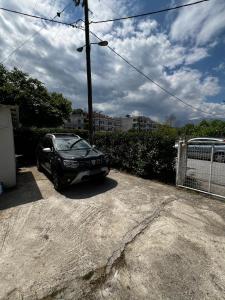 a car parked in a driveway in a parking lot at Olympus and Sea View Apartment in Platamonas
