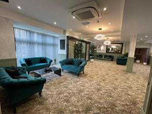 فندق روسكين في بلاكبول: لوبي فيه كنب وكراسي في غرفة