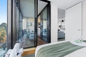 Charming Seaside Retreat في ملبورن: غرفة نوم بسرير وإطلالة غرفة معيشة