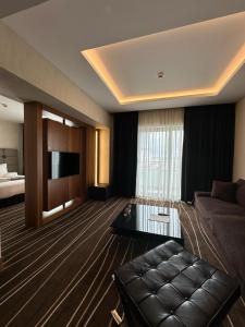 a living room with a couch and a television at Cihangir Hotel Bosphorus in Istanbul
