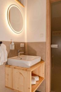 a bathroom with a sink and a mirror at Müller's Stuben in Isny im Allgäu