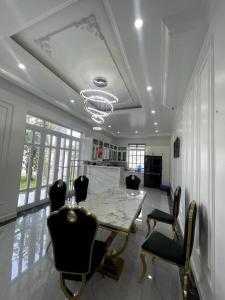 a dining room with a table and chairs at Villa for rent in Tra Vinh City in Xóm Vàng