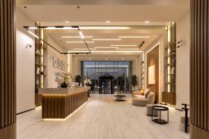 a lobby of a hotel with a reception desk at Abidos Hotel Apartment Dubai Land in Dubai