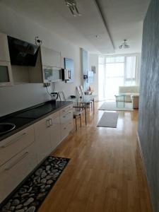 a kitchen with a counter and a living room at apartmán 21-th floor Bratislava Petrzalka (building Vienna Gate) in Bratislava