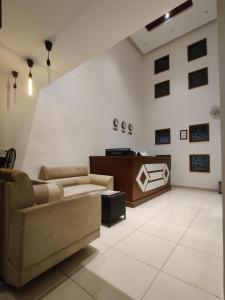 a living room with a couch and a table at Airport Regency in Devanahalli-Bangalore