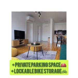 a living room with a couch and a table at Apartman 4 STAR in Osijek
