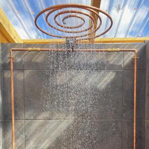 a shower in a bathroom with a hose at Foxglove Field Glamping in Perranuthnoe