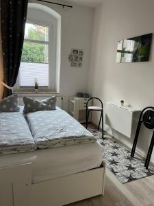 a white bedroom with a bed and a window at Gästewohnung zum Heiligen Grund in Meißen +17 photos