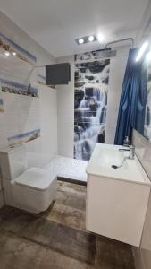 a bathroom with a toilet and a sink and a shower at Apartamento Vista Mar Arrecife in Arrecife