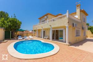 a villa with a swimming pool in front of a house at Villa Delicia by Abahana Villas in Calpe