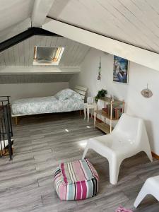 a room with two beds and a table and a chair at Brezza Marina in Diano Marina