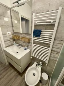 a bathroom with a white sink and a toilet at Brezza Marina in Diano Marina +22 photos