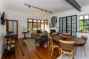 sala de estar con mesa de madera y sillas en La Maison On Main Self-Catering Villa, en Paarl