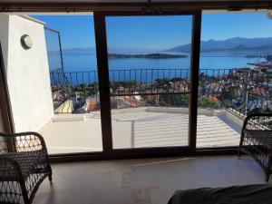 a room with a large window with a view of the water at Terrace Urla in Urla
