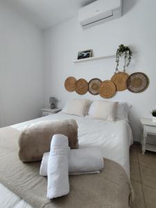 a white bedroom with a large white bed with pillows at Villas Rodríguez in Playa Blanca
