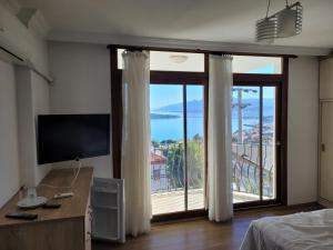 a bedroom with a large window with a view at Terrace Urla in Urla