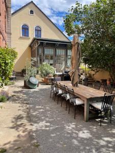 a wooden table and chairs in front of a house at Lark in Schleibnitz