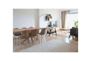 a dining room table and chairs in a living room at La Resina 3BD 2 BTH - SUN&RELAX in Estepona
