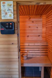 a sauna with a bench in a wooden wall at Hiška Gmajna in Slovenj Gradec