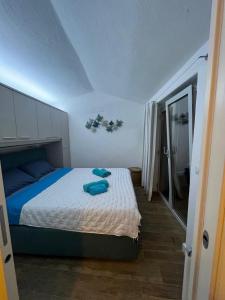 a bedroom with a bed with blue pillows on it at VILLA ŚWISTAKKO in Costa Paradiso