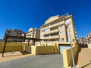 a building with a street light in front of it at Apartamentos Canet de Berenguer 3000 in Canet de Berenguer