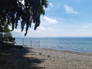 a beach with the ocean in the background at Ferienzentrum Bodensee in Oberteuringen