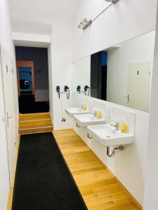a bathroom with two sinks and two mirrors at Space Home Apartment - Downtown in Vienna