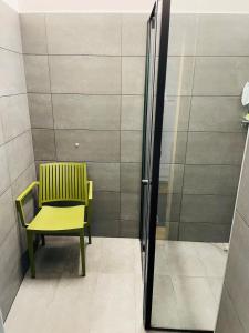 a yellow chair and a green chair in a room at Space Home Apartment - Downtown in Vienna +8 photos