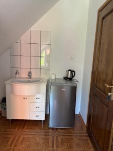 a small bathroom with a sink and a sink at Hotelik Maria in Szczytno
