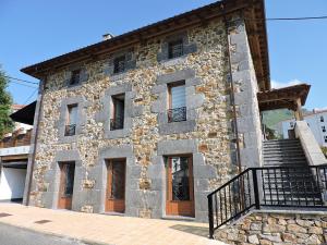 a stone building with a staircase in front of it at Casas Piedra in Arredondo
