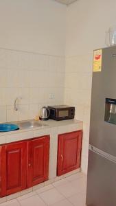 a kitchen with a sink and a toaster oven at Charly chic-agla in Cotonou