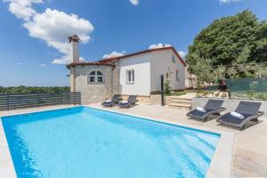 a villa with a swimming pool and a house at Villa Aria private Pool near Vrsar in Vrsar