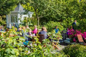 a group of people sitting in a garden at Puffin Nest, Superior Apartment in Reykjavík
