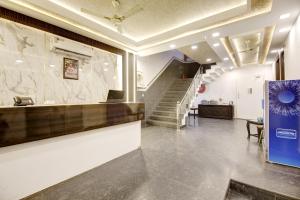 a lobby of a building with a staircase and a counter at Hotel Devrana Delhi in New Delhi