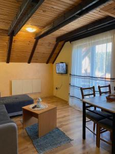 a living room with a couch and a table at Apartment Tarski konaci in Mitrovac