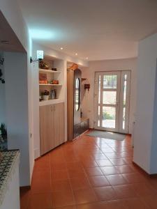 a hallway with a door and a tile floor at Edelweiss Ilinca in Zărneşti