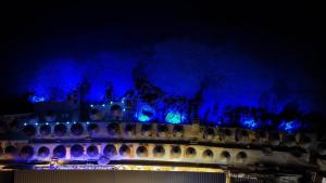un castillo iluminado por la noche con luces azules en Siro Kerma Private Beach Villa en Sarandë