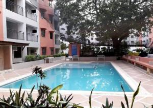 a swimming pool in the middle of a building at Otravel Hostel 4 minutes from Mactan Airport in Pusok