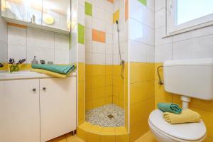a bathroom with a shower and a toilet and a sink at Villa Mare Komiža in Komiža +128 photos