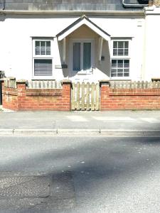 a brick fence in front of a house at Turnstone in Seaton