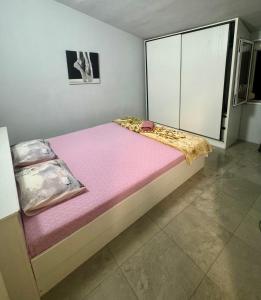 a large bed in a room with a large window at Hostel Lejla in Podgorica