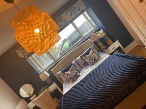 an overhead view of a bedroom with a bed and a window at The Coach House & The Stables Holiday Homes Windy Bank Hall Green Moor Yorkshire Peak District in Wortley