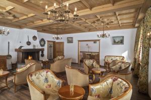 a living room with chairs and a fireplace at Bad Serneus Water Resort in Klosters