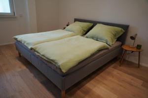 a bed with two pillows on it in a room at Loft Neunkirchen in Neunkirchen am Brand