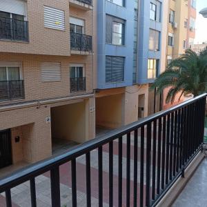 ein Mehrfamilienhaus mit Balkon und Palme in der Unterkunft Alicante Habitación Oasis in Alicante