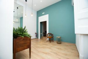 a hallway with blue walls and a wooden floor at Palazzo Goyze in Naples