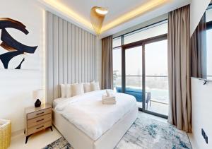 a bedroom with a large bed and a large window at Amazing View Marina Vista High Floor in Dubai