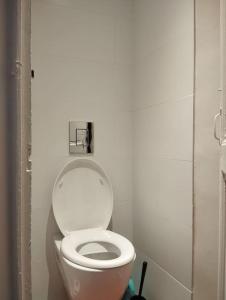 a bathroom with a white toilet in a stall at Appartement de charme - WIFI - Centre historique in Toulon +18 photos