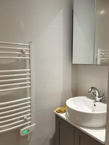 a white bathroom with a sink and a mirror at Appartement de charme - WIFI - Centre historique in Toulon